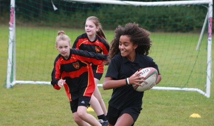Students playing Rugby in PE class