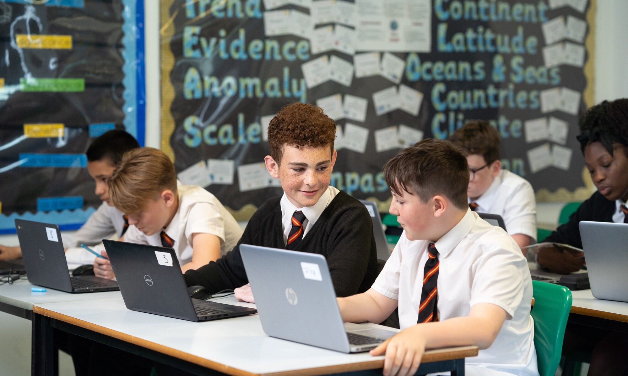 Students engaged and discussing discoveries during IT classroom